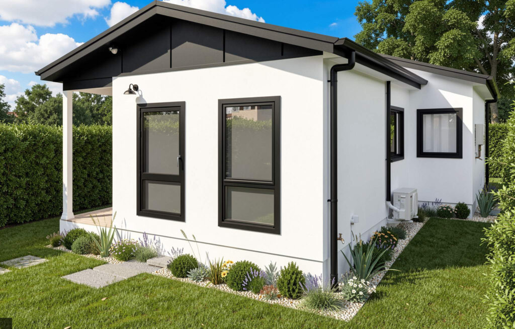 Modern white granny flat with black trim and large windows in landscaped Sydney backyard with green lawn
