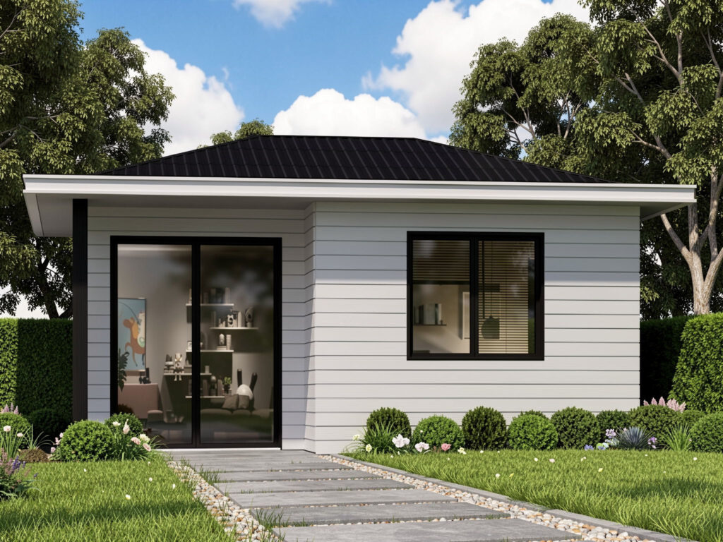 Modern single-story granny flat with white weatherboard cladding, dark roof, large glass doors and landscaped garden